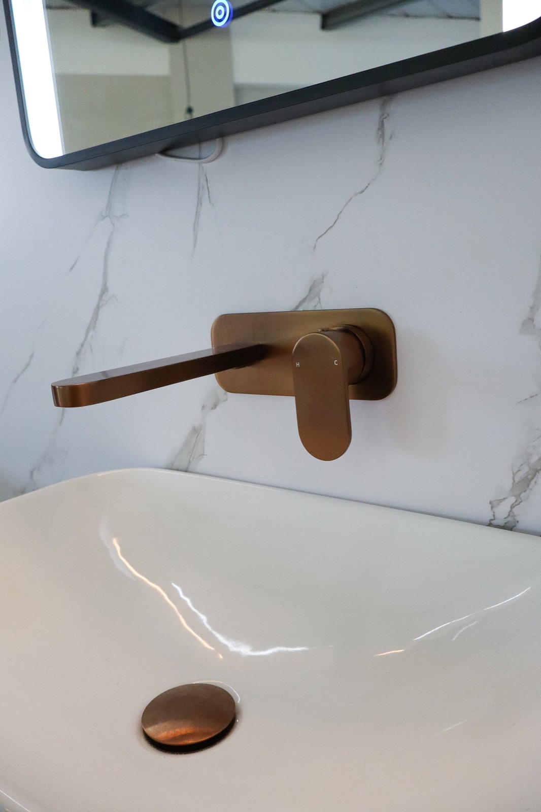 Close-up of brass tapware on display in the JTS bathroom showroom